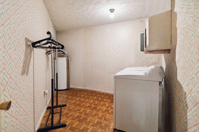 clothes washing area featuring cabinets, washer and clothes dryer, dark parquet floors, and a textured ceiling