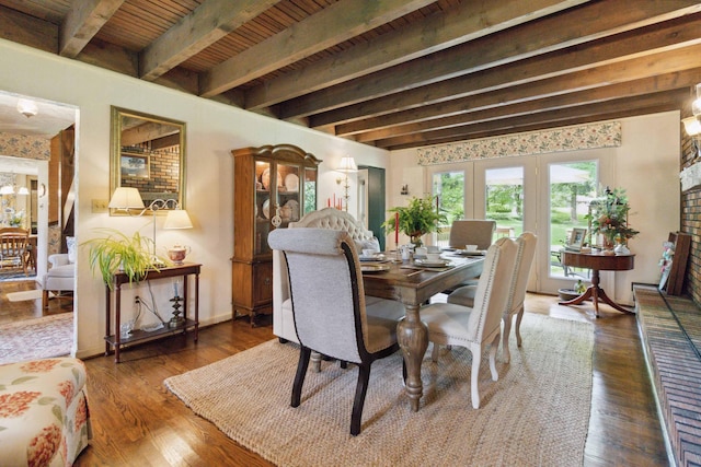 dining area featuring beam ceiling and dark hardwood / wood-style flooring