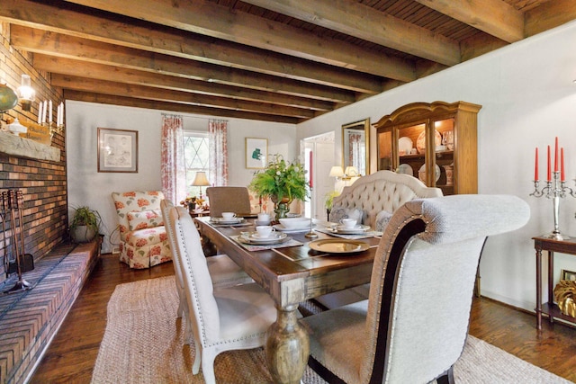 dining area featuring beamed ceiling, dark hardwood / wood-style floors, and wooden ceiling