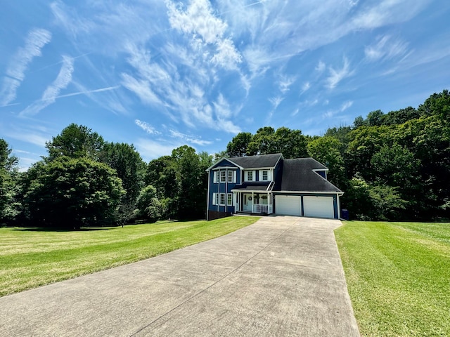 view of front of property with a garage and a front lawn