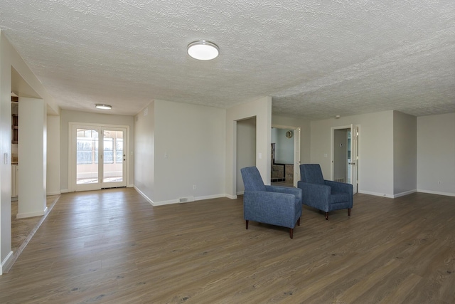 unfurnished room featuring dark hardwood / wood-style floors and a textured ceiling