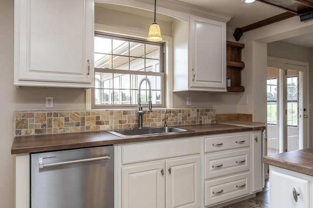 kitchen with sink, wooden counters, dishwasher, tasteful backsplash, and white cabinets