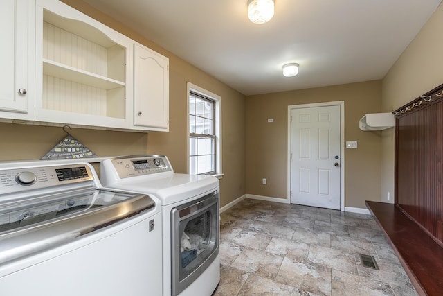 laundry area featuring cabinets and washing machine and clothes dryer