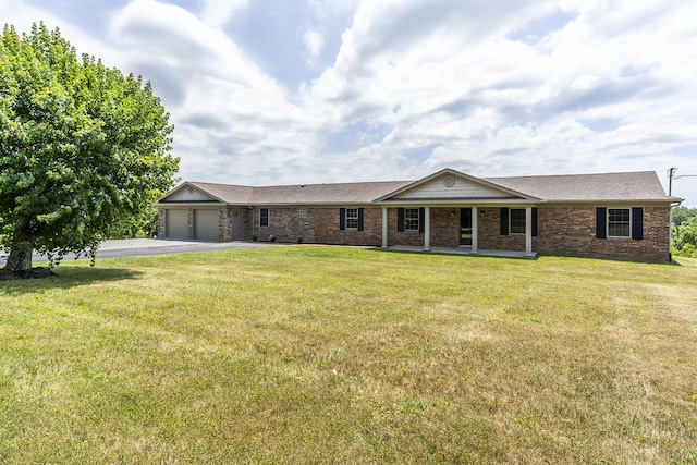 ranch-style house featuring a garage and a front yard