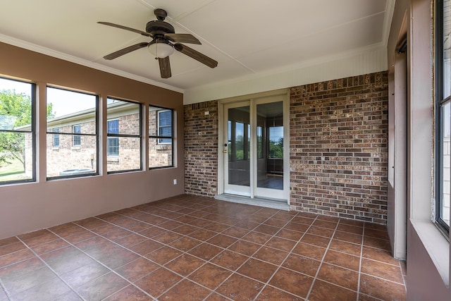 unfurnished sunroom with ceiling fan