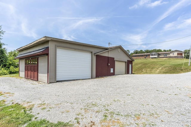 garage featuring a lawn