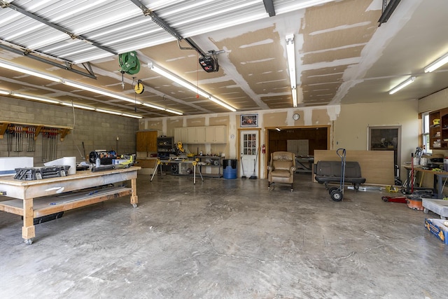 garage featuring a garage door opener and a workshop area