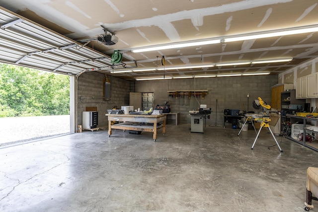 garage featuring electric panel and a workshop area