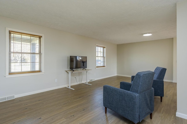 sitting room featuring hardwood / wood-style floors and a textured ceiling