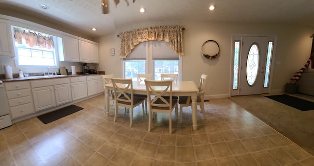 carpeted dining room with a wealth of natural light and sink