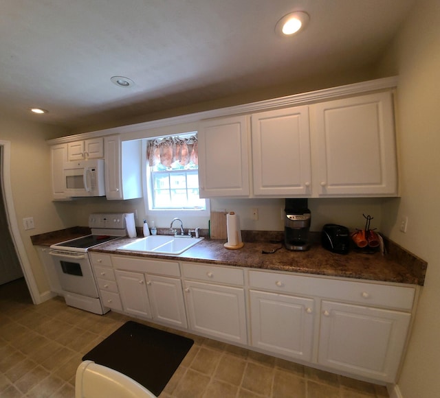 kitchen with white cabinets, white appliances, and sink