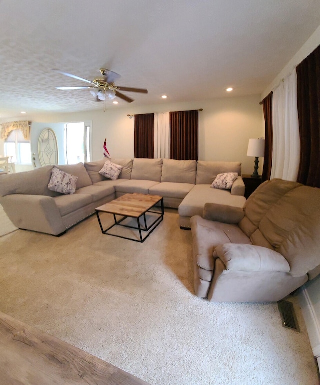 living room with ceiling fan and light carpet