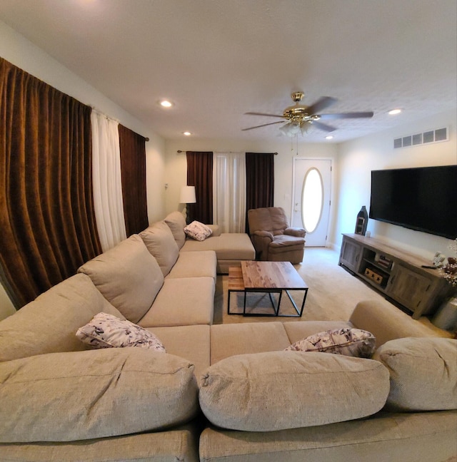 living room featuring light colored carpet and ceiling fan