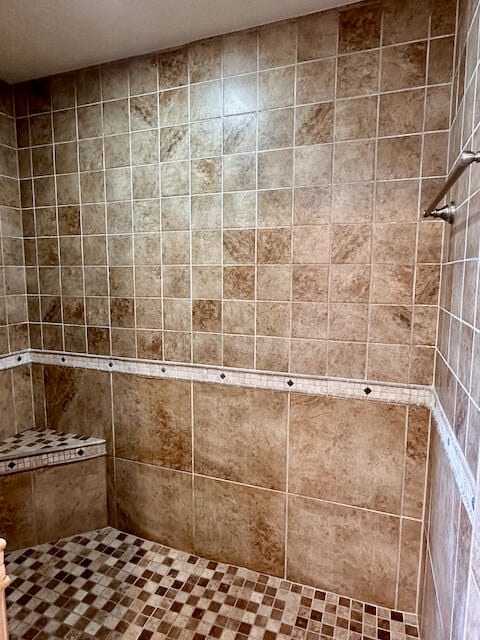 bathroom with a tile shower