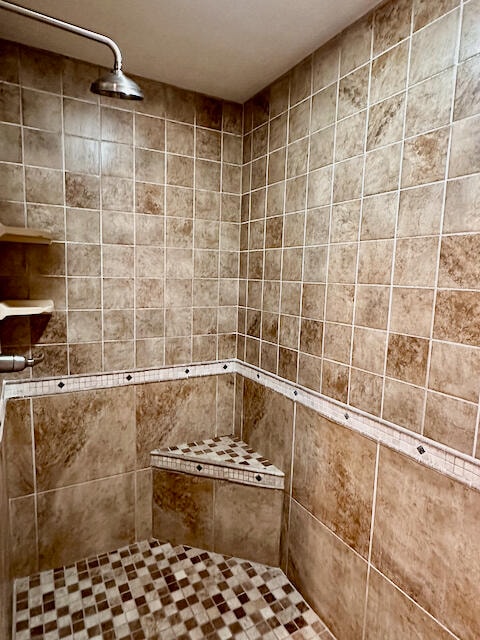 bathroom with tiled shower