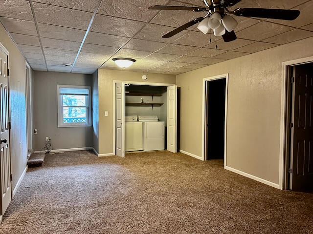 unfurnished bedroom with carpet flooring, separate washer and dryer, and ceiling fan