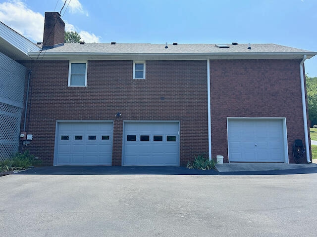 back of property featuring a garage