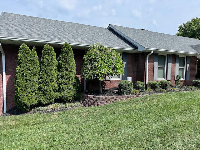 view of side of property with a yard