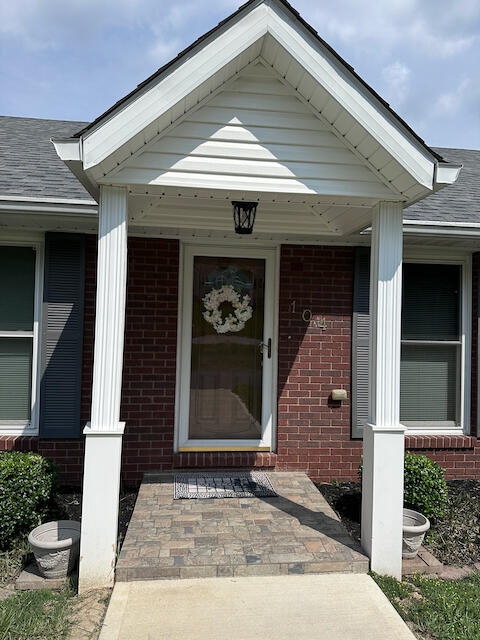 view of exterior entry with a porch