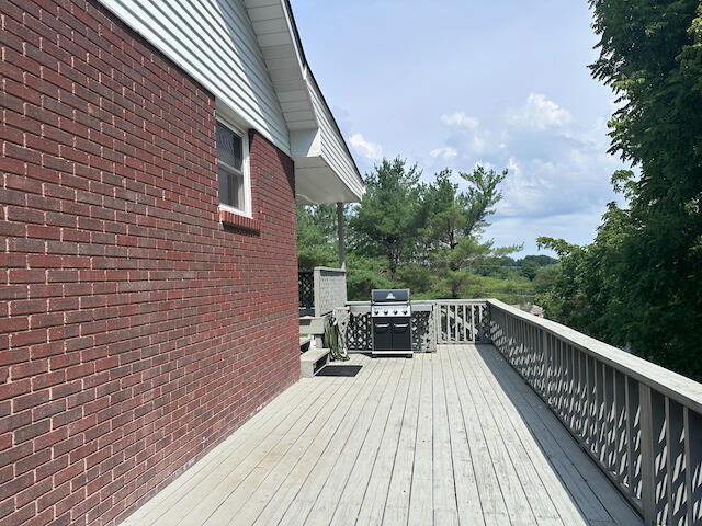 wooden deck featuring area for grilling