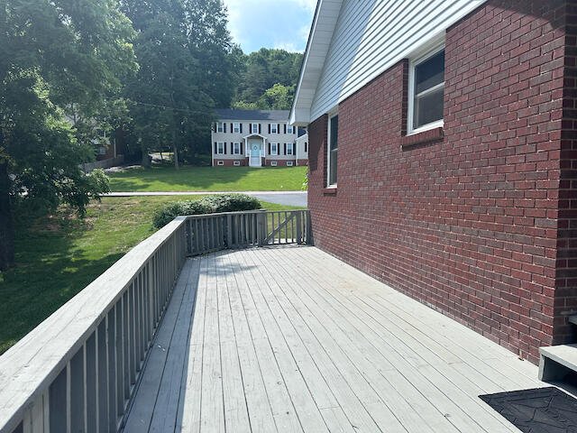 wooden deck featuring a yard