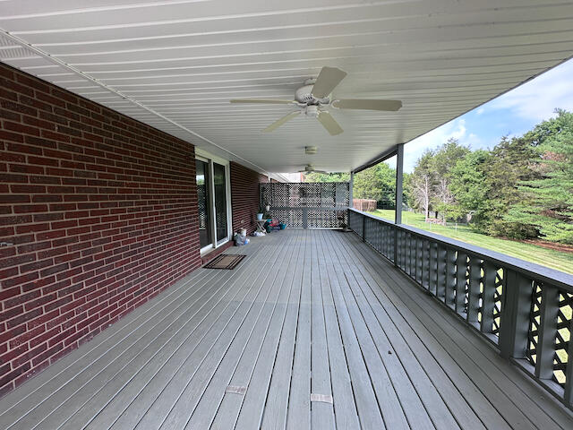 wooden deck featuring ceiling fan