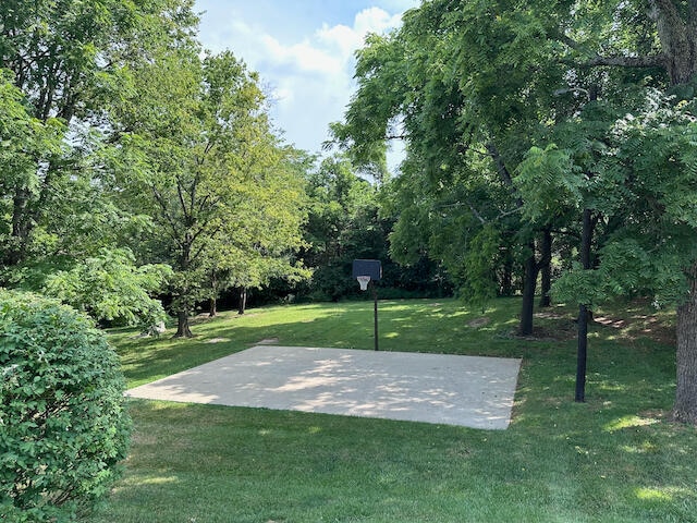 view of basketball court featuring a yard