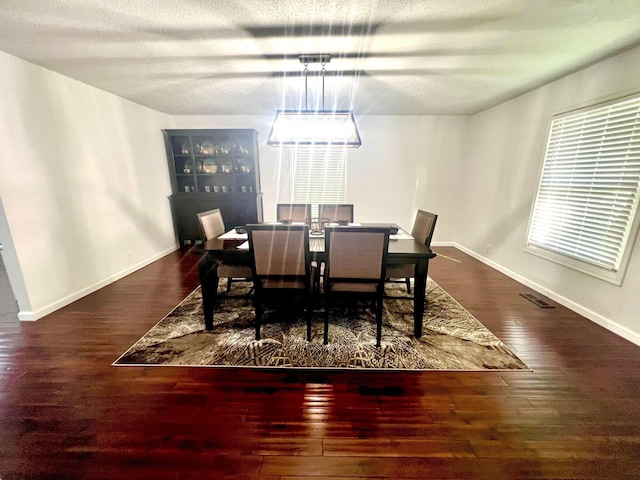 dining space with dark hardwood / wood-style flooring