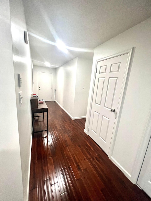 hallway with dark wood-type flooring