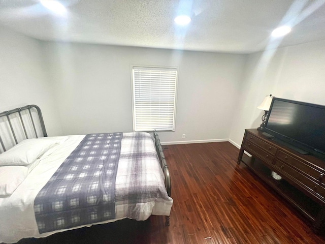 bedroom with dark hardwood / wood-style flooring