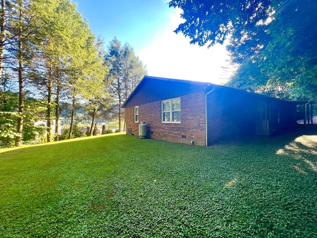 view of side of property featuring a lawn and cooling unit