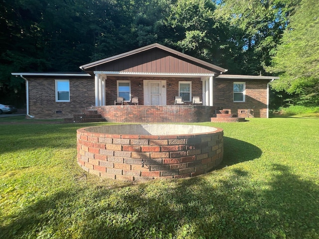 view of front of home with a front yard and a porch