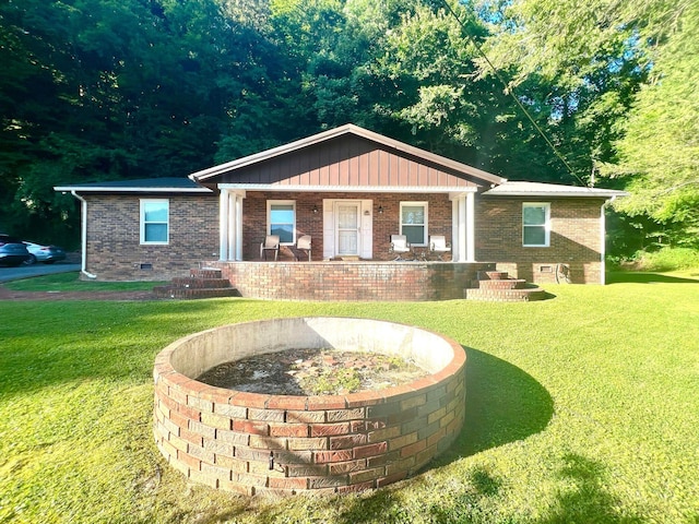 view of front of property with covered porch and a front yard