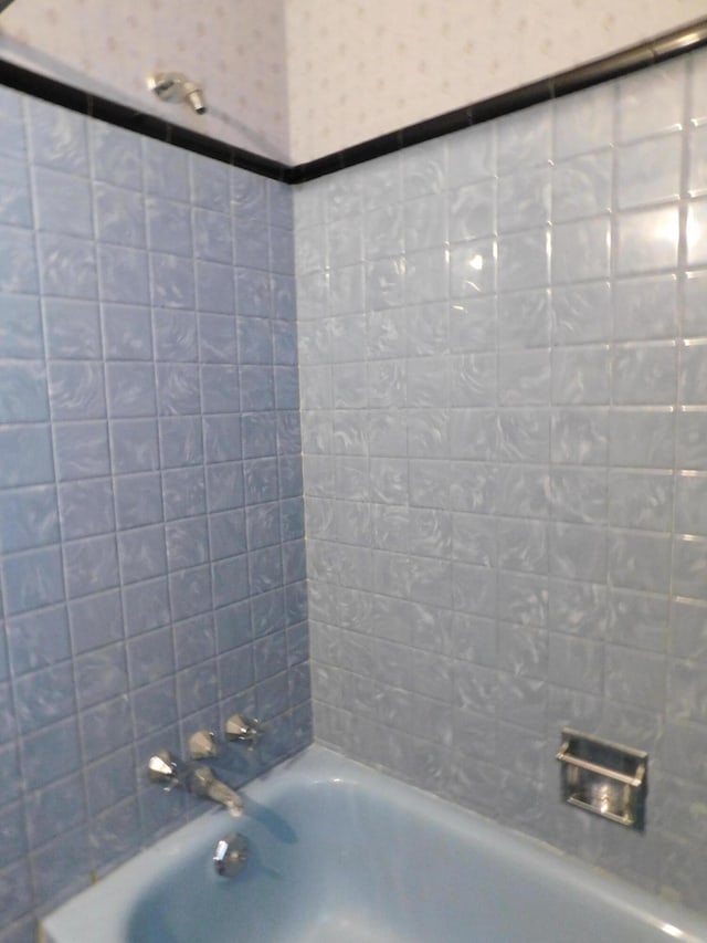 bathroom featuring wallpapered walls and washtub / shower combination