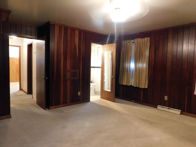 interior space with wood walls and baseboard heating