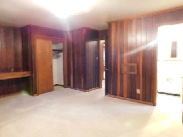 unfurnished room featuring wood walls