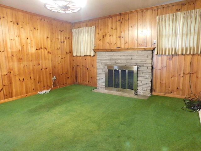 unfurnished living room featuring carpet floors, a stone fireplace, and wooden walls