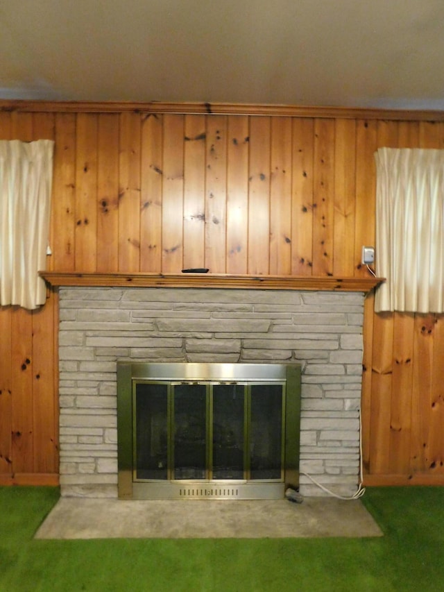 details featuring carpet, a fireplace, and wooden walls