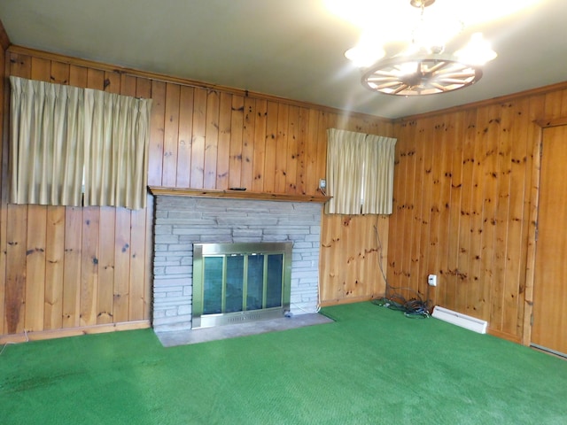 unfurnished living room featuring wood walls, carpet, a fireplace, and crown molding