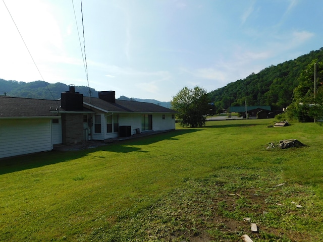 view of yard featuring central air condition unit