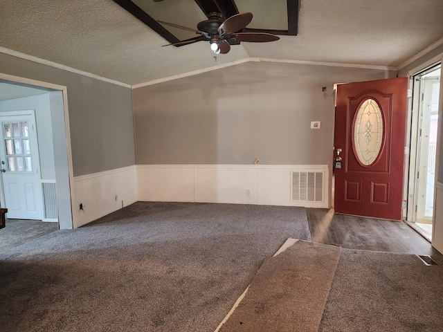 entryway with a textured ceiling, crown molding, ceiling fan, and vaulted ceiling