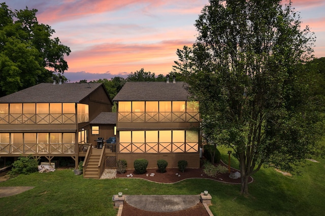 back house at dusk with a yard