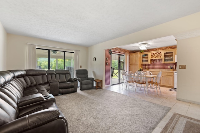 tiled living room featuring a textured ceiling and ceiling fan