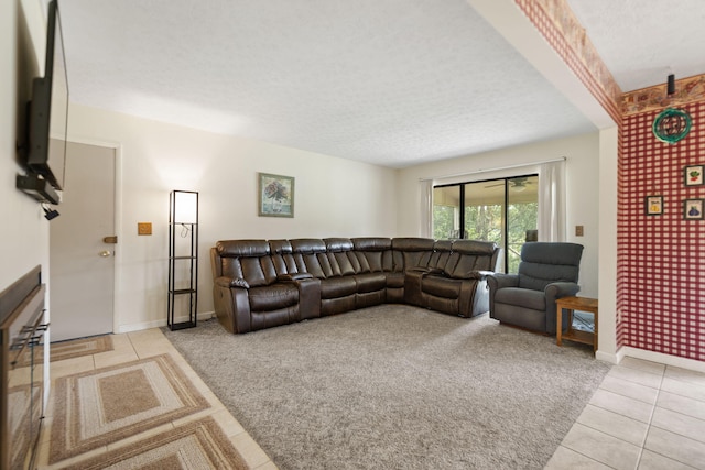 living room featuring a textured ceiling and light tile patterned floors