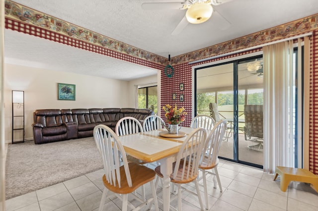 dining room featuring a textured ceiling, ceiling fan, and light tile patterned floors