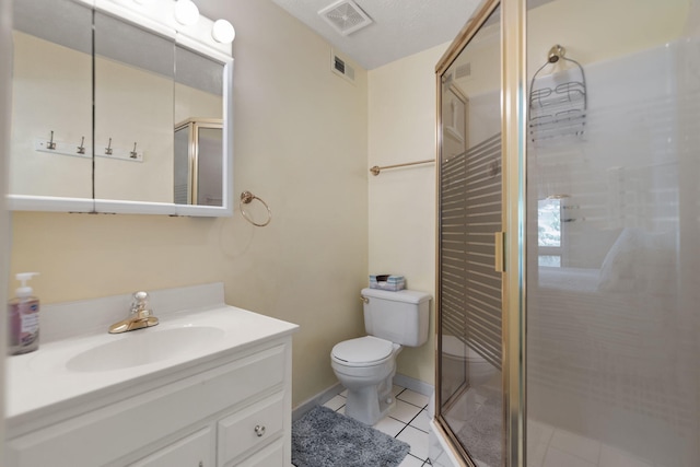 bathroom featuring an enclosed shower, vanity, tile patterned floors, and toilet