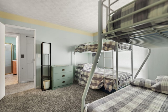 carpeted bedroom featuring a textured ceiling