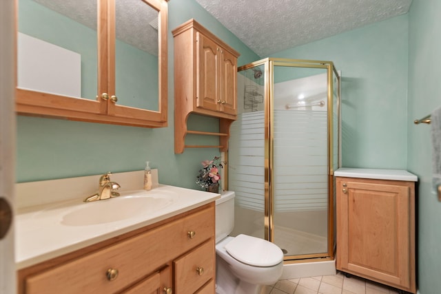 bathroom featuring vanity, tile patterned floors, a shower with shower door, toilet, and a textured ceiling