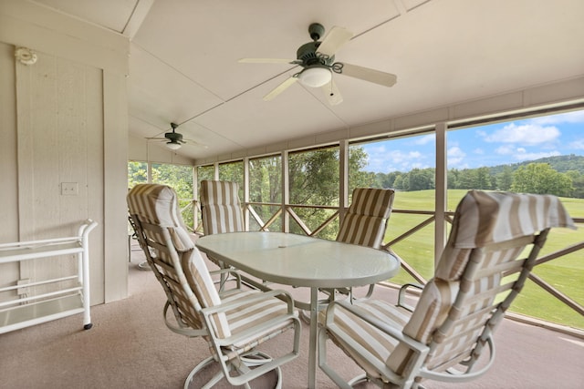 sunroom featuring ceiling fan