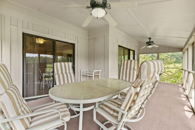 sunroom with lofted ceiling and ceiling fan